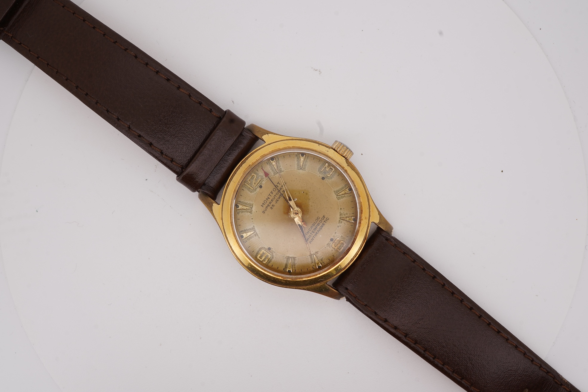 A gentleman's steel and gold plated Montfort Superautomatic wrist watch, with Roman and quarterly Arabic numerals, case diameter 34mm, on a later associated leather strap.